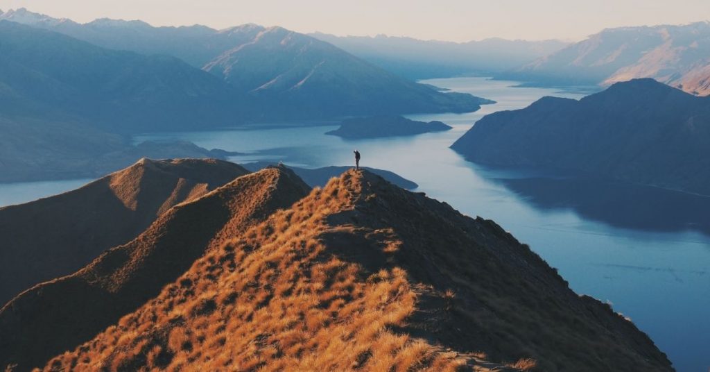 person standing atop a mountain