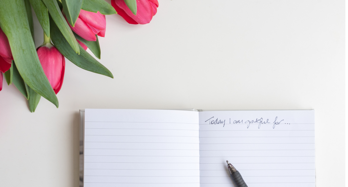 open book with a pen on a desk